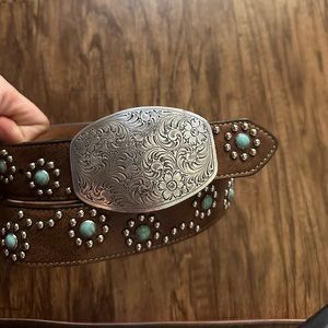 1994 vintage leather belt with turquoise accents and a embossed silver buckle.